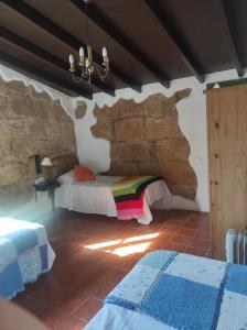 um quarto com uma cama e uma parede de pedra em Villa los gavilanes em Santa Cruz de Tenerife