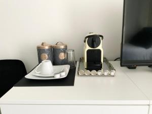 una mesa con cafetera y set de té. en EXECUTIVE SINGLE ROOM WITH EN-SUITE in GUEST HOUSE CITY CENTRE, en Luxemburgo