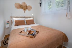 a bedroom with a bed with a tray of food on it at Cosy private boho app Nook in Rijeka near Opatija in Rijeka