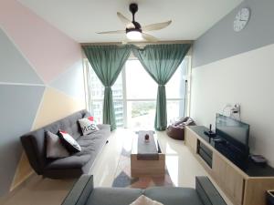 a living room with a couch and a tv at Medini Signature x 3min to Legoland x 2BR x 7pax in Nusajaya