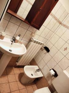 a bathroom with a sink and a toilet at La casetta di Ste in Pigna