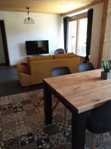 a living room with a couch and a table at Tres bel appartement dans une maison avec SPA in Séez