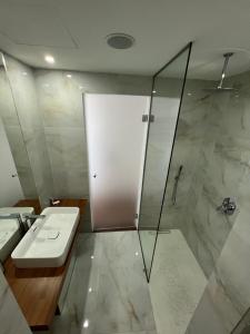 a bathroom with a shower and a toilet and a sink at Kanes Boutique Hotel in Sarandë