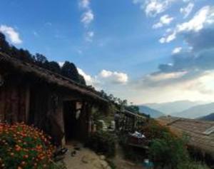 a building with flowers on the side of it at Bursol Homestay by StayApart in Chamoli