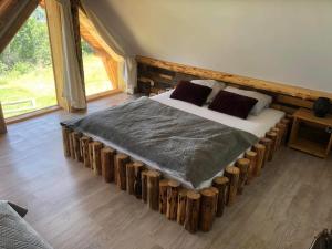 a bedroom with a bed made out of logs at Rochowa Buznica in Zakopane