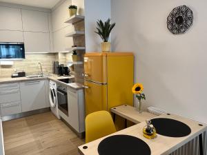 a kitchen with a yellow refrigerator and a table at Apartmán U Pelikána in Olomouc