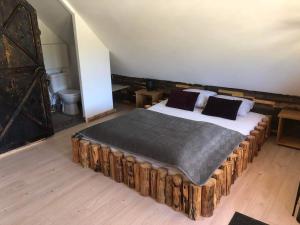 a bedroom with a bed made out of logs at Rochowa Buznica in Zakopane