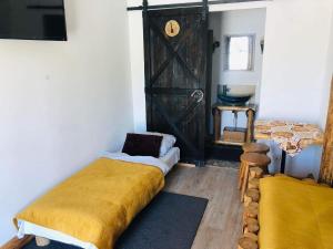a bedroom with a bed with a yellow blanket at Rochowa Buznica in Zakopane