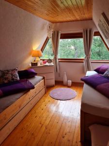 a bedroom with two beds and a large window at Ferienhaus Elbeflair in Belgern