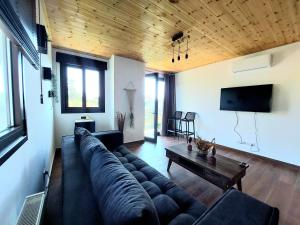 a living room with a large couch and a table at Agros Green Valley Suites in Limassol