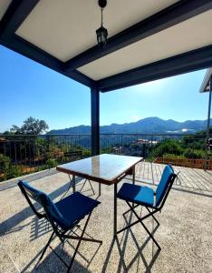 a table and two chairs on a patio with a view at Agros Green Valley Suites in Limassol