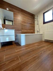 a bathroom with a tub and a sink and a mirror at Agros Green Valley Suites in Limassol +53 photos