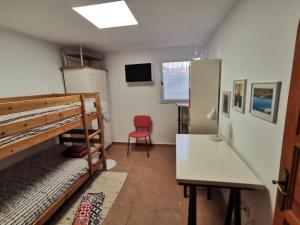 a dorm room with a bunk bed and a desk at Casa Morisca in Tossa de Mar