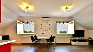 comedor con sillas, mesa y reloj en la pared en Apartment Anna Maria, en Rakovica