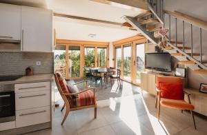a kitchen and living room with a table and chairs at Kuća za odmor Vlahek in Grabrovnik