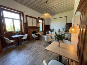 a restaurant with tables and chairs and a window at O'Cottage suite Familiale in Annonay