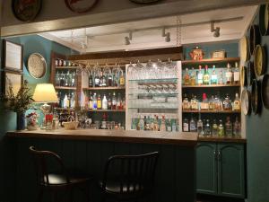 a bar with two chairs and alcohol bottles at Deerhill Inn in West Dover