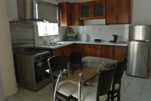 a kitchen with a table and chairs and a refrigerator at central square HOUSE kokalaki in Kefalos