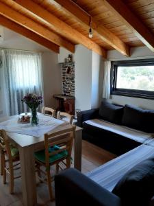 a living room with a table and a couch at Traditional house in Akamatra square in Akamatra