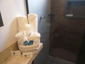 a bathroom with towels on a counter next to a shower at Casa 3 Encanto dos Mares in Barra Velha