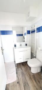 a white bathroom with a toilet and a sink at Appartement Ajaccio vue mer panoramique in Ajaccio +22 photos