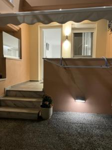 a hallway with stairs and a potted plant in a building at Rani Apartments in Chrysi Ammoudia +70 photos