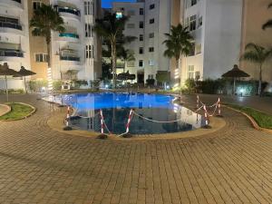 a pool in the middle of a building at night at PERLA NOUACEUR AéROPORT MOHAMMED V in Nouaceur