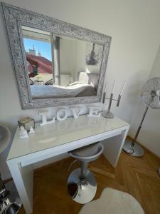a white desk with a mirror on a wall at PANORAMIC FAMILY APT with FREE TWO PARKING PLACE AND BREAKFAST in Budapest