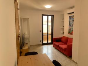 a living room with a red couch and a table at Nardò Kiss in Nardò