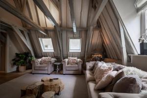 a living room with a couch and chairs and a table at Sterlogies City Penthouse in Leeuwarden