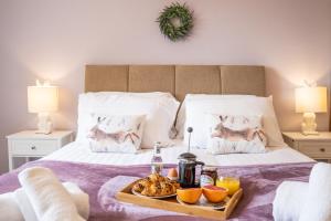 a tray of food on top of a bed at Morea Cottage - 2 Bed in Horning