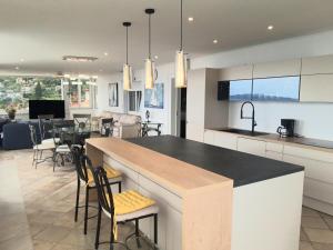 a kitchen and dining room with a large island in a kitchen at Apartments Darijana in Opatija