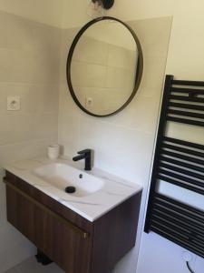 a bathroom with a sink and a mirror on the wall at Studio au calme vue sur garlaban in Roquevaire