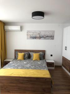 a bedroom with a large bed with yellow pillows at Вила TIMeS in Kiten