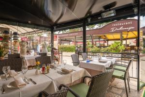 a restaurant with white tables and chairs in front of a building at Boutique Hotel Villa Pattiera in Cavtat