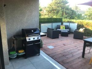 eine Terrasse mit einem Grill, Stühlen und einem Tisch in der Unterkunft Argelès sur mer appartement standing in Argelès-sur-Mer