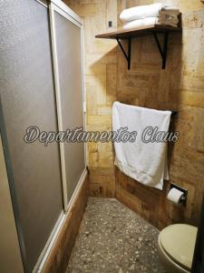 a bathroom with a shower and a toilet and a towel at Suite Claus in Acapulco