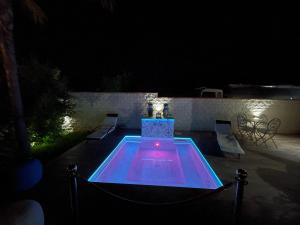 ein nachts beleuchteter Swimmingpool in der Unterkunft Relais Dea Degli Ulivi in Agrigento