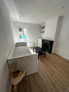 a bedroom with a bed and a chair and a fireplace at Appartement Centre ville Le Havre in Le Havre