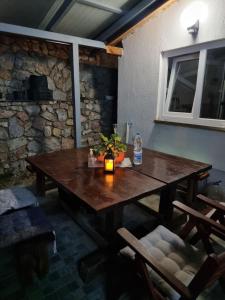 a wooden table in a room with a stone wall at Vila Anastas in Ohrid