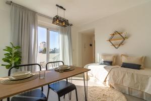 a bedroom with a bed and a table with chairs at Acevedo 716 - Apart Hotel - New opening in Buenos Aires