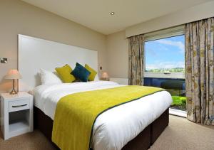 a bedroom with a large bed and a large window at The View at the White Horse Woolley Moor in Clay Cross