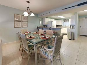 a kitchen and dining room with a table and chairs at Sandy Key #323 in Perdido Key +44 photos