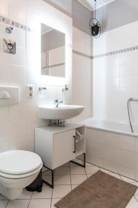 a white bathroom with a sink and a toilet at Kaßberg - Studio mit Balkon, Netlfix und Wifi in Chemnitz