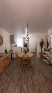 a dining room and kitchen with a table and chairs at Là Casa 1908 in Le Porge