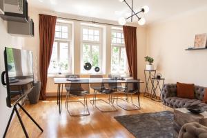 a living room with a table and a couch at Kaßberg - Studio mit Balkon, Netlfix und Wifi in Chemnitz