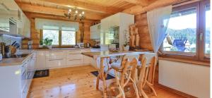 a kitchen with white cabinets and a wooden ceiling at Góralski Sen in Ochotnica Górna