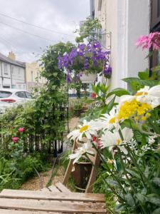 a garden with flowers and a basket of flowers at Mulgrave Lodge in Dun Laoghaire