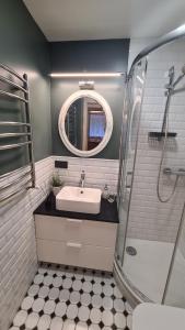 a bathroom with a sink and a mirror at Your Space in Jurmala in Jūrmala