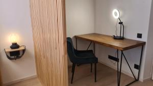 a desk and a chair next to a desk with a lamp at Your Space in Jurmala in Jūrmala